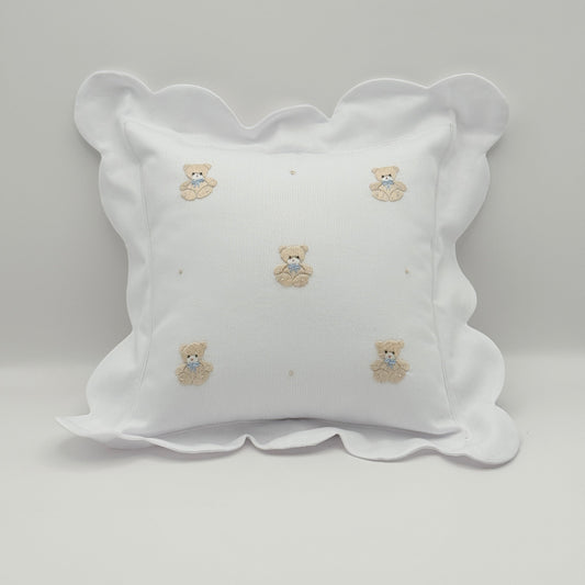Decorative pillow with embroidered teddy patterns on a plain background