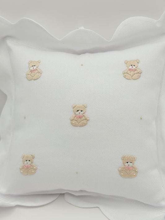 White fabric with embroidered teddy bear designs on a white background